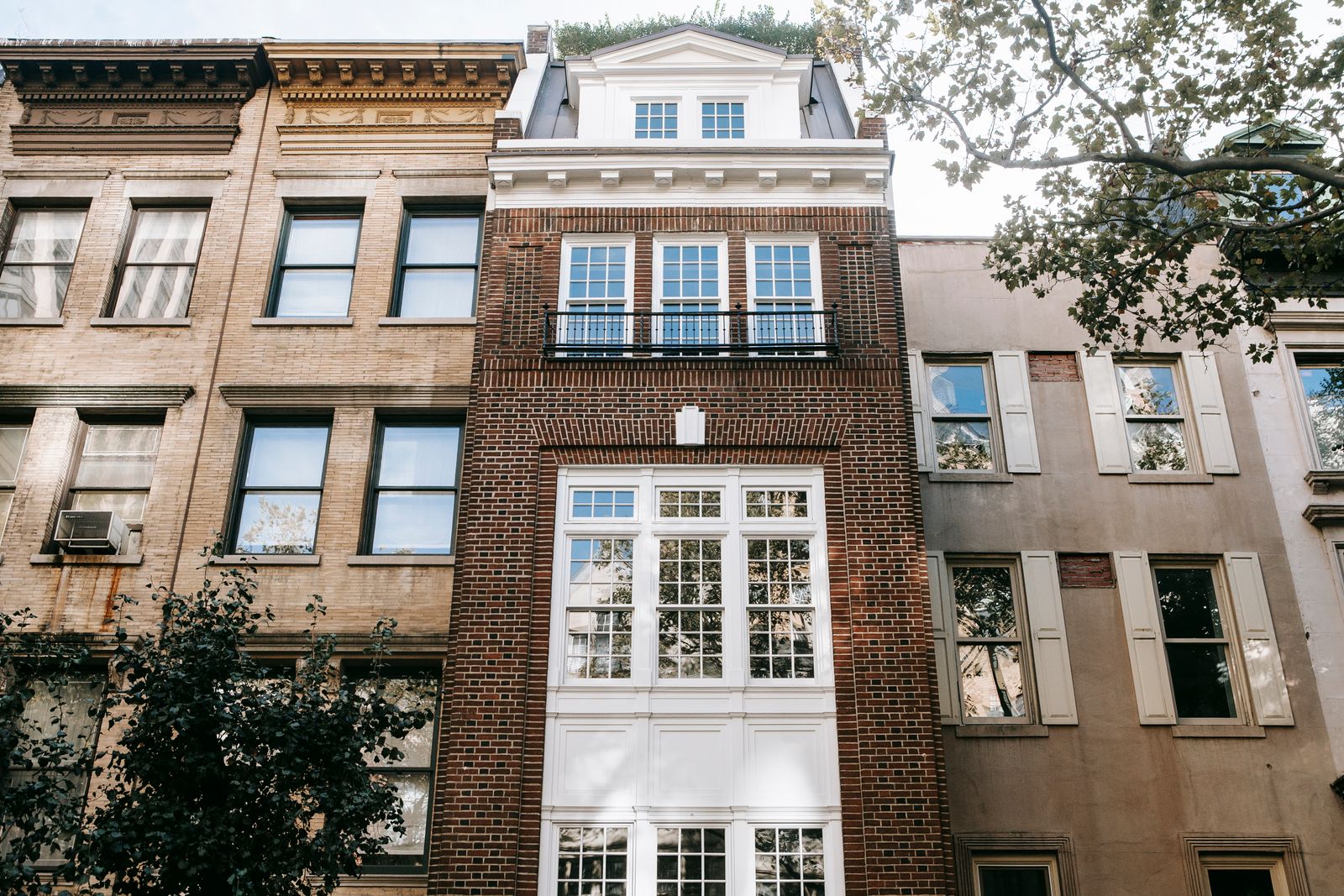 Brick rowhouses photographed from the street; illustrative residential photography